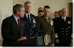 President George W. Bush speaks at the Pentagon Tuesday, March 25, 2003. Also pictured, from left, are Chairman of the Joint Chiefs of Staff General Richard B. Myers, Vice Chairman of the Joint Chiefs of Staff General Peter Pace and Chief of Naval Operations Admiral Vern Clark. White House photo by Paul Morse.