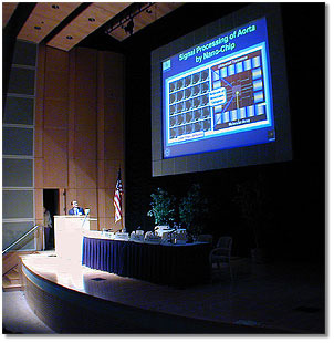 Photo of speaker and slide