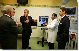 President George W. Bush listens to a demonstration by Dr. Neal Patel on the benefits of using information technology in hospitals at Vanderbilt Children’s Hospital in Nashville, Tenn., May 27, 2004. White House photo by Paul Morse.