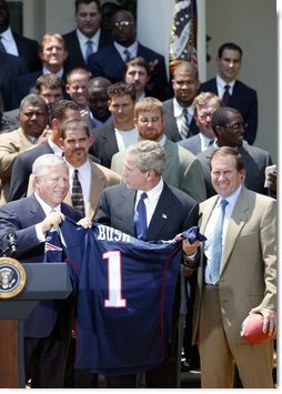 President George W. Bush receives a jersey from New England Patriots owner Bob Kraft and coach Bill Belichick during a photo opportunity with the Super Bowl champions in the Rose Garden on May 10, 2004. White House photo by Paul Morse.