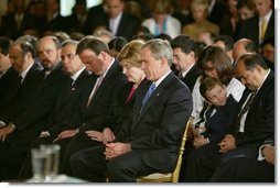 President George W. Bush and Laura Bush bow their heads in prayers during a White House ceremony honoring Cinco de Mayo in the East room Wednesday, May 5, 2004. "Mexican Americans have brought many strengths to our nation: a culture built around faith in God, a deep love for family, a belief that hard work leads to a better life," said the President in his remarks. "Every immigrant who lives by these values makes our country better and makes our future brighter." White House photo by Paul Morse.