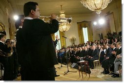 President George W. Bush listens to Banda El Recodo during a White House ceremony honoring Cinco de Mayo in the East room Wednesday, May 5, 2004. Mexican recording artists Marco Antonio Solis and Jimena also performed during the event.  White House photo by Paul Morse.