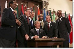 President George W. Bush signs into law the African Growth and Opportunity Act (AGOA) Acceleration Act of 2004 in the Dwight D. Eisenhower Executive Office Building Tuesday, July 13, 2004. White House photo by Paul Morse.