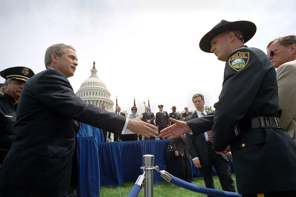 President George W. Bush greets a police officer from Flagstaff, AZ., after placing a wreath to commemorate the 20th Annual Peace Officers Memorial Service at the Capitol. WHITE HOUSE PHOTO BY ERIC DRAPER