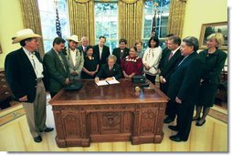 President George W. Bush signs an Executive Memorandum on Tribal Sovereignty and Consultation in honor of the opening of the National Museum of the American Indian, Thursday, Sept. 23, in the Oval Office. White House photo by Tina Hager.