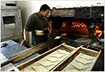 An Iraqi baker cooks traditional bread in Baghdad on April 22, as life slowly returns to normal in Baghdad.