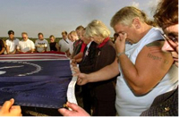 Photo:  Secretary Norton, third from right, helps hold a giant Flight 93 flag during a moment of silence on Sept. 11, 2003, in memory of the those killed aboard United Flight 93 two years ago. Second from right is Terry Butler of Somerset, Pa., who witnessed the crash. 