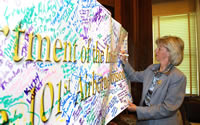 Photo of Secretary Norton signing Support Our Troops Banner
