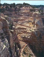 A MULE PARTY CLIMBS THE STEEP SWITCHBACKS THROUGH THE KAIBAB LIMESTONE ON THE SOUTH KAIBAB TRAIL. STEEP SWITCHBACKS DROP THROUGH THE ALMOST VERTICAL CHIMNEY AT THE HEAD OF SOUTH KAIBAB TRAIL. GRAND CANYON NATIONAL PARK.