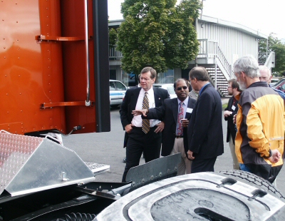 photo of partners examining diesel truck