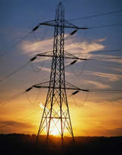 Picture of powerlines and transformer at sunset.