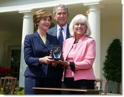 President George W. Bush and First Lady Mrs. Laura Bush with Kathleen Mellor the 2004 Teacher of the Year from South Kingstown, Rhode Island in the Rose Garden of the White House on April 21, 2004. White House photo by Paul Morse.