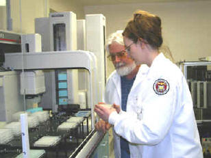Image depicting William Branham and Cathy Melvin demonstrating the microarray creation process.