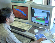 Photo of researchers working on a computer model.