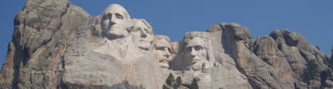 The four presidential faces of Mount Rushmore, Washington, Jefferson, Roosevelt and Lincoln.