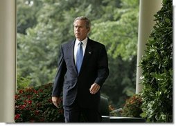 President George W. Bush enters the Rose Garden where he talks about America's intelligence reforms Monday, Aug. 2, 2004.  White House photo by Paul Morse.