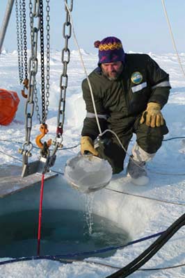 Arctic research collects sea water samples from sea ice.