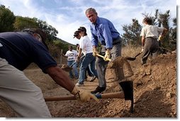 Working alongside volunteers, President George W. Bush lends a hand in repairing the Old Boney Trail at the Santa Monica Mountains National Recreation Area in Thousand Oaks, Calif. File photo. White House photo by Paul Morse.