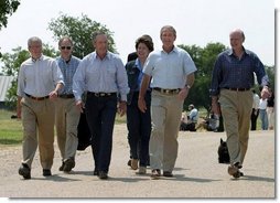 After talking with the press, President George W. Bush walks with his economic advisors at his ranch in Crawford, Texas, Wednesday, August 13, 2003. Pictured are, from left, Director of the Office of Management and Budget Josh Bolten, Assistant to the President for Economic Policy Stephen Friedman, Secretary of Commerce Don Evans, Secretary of Labor Elaine Chao and Secretary of the Treasury John Snow.  White House photo by Susan Sterner.