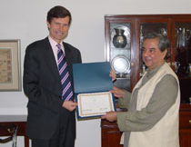 The United States announced two grants totaling $230,000 for community-based programs to reduce indoor air pollution from household energy use in India. Seen in the picture is U.S. Embassy Deputy Chief of Mission Robert O. Blake presenting the grant to one of the recipients, New Delhi, November 8, 2004