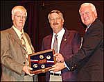 Photograph of Leigh Frederickson being presented a plaque by Dean Rundle and Deputy Interior Secretary Steven Griles.