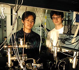 University of Illinois at Chicago Ph.D. student Li-Bang Wang (right) and postdoctoral fellow Peter Mueller set up the equipment to trap and detect the helium-6 nuclei. 