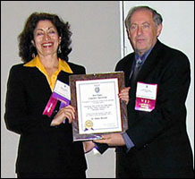 Photo of Bahar receiving a plaque from Dr. Russell Vacante, President, SOLE.