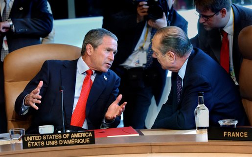President George W. Bush talks with French President Jacques Chirac at the start of the G8 leaders' working session in Kananaskis, Canada, Thursday, June 27. White House photo by Eric Draper.