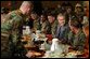 President George W. Bush enjoys lunch with U.S. soldiers at Fort Carson, Colorado Nov. 24, 2003. White House photo by Tina Hager White House photo by Tina Hager.