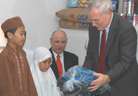 U.S. Ambassador Lynn Pascoe delivers gifts to children from orphanage in celebration of Ramadan