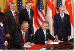 President George W. Bush and Singapore Prime Minister Chok Tong Goh sign a free trade agreement in the East Room Tuesday, May 6, 2003. White House photo by Tina Hager.