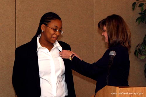 Deputy Assistant to the President and Director of USA Freedom Corps Desiree T. Sayle presents the Presidents Volunteer Service Award to Alexandria Canada-Marcus at the Learn and Serve America Grantee Training Conference in Bethesda, Maryland, on Monday, November 8, 2004. Canada-Marcus, 16, participates in a Learn & Serve America class at Roosevelt High School in Washington, D.C. Through the class, she began volunteering at Community Harvest, a local nonprofit organization that works to combat hunger.  Learn and Serve America, a program under the direction of the Corporation for National and Community Service, supports service-learning programs in schools and community organizations that each year help nearly two million students meet community needs while improving their academic skills and learning the habits of good citizenship. Learn and Serve America grants are used to create new programs or replicate existing programs, as well as to provide training and development to staff, faculty, and volunteers.