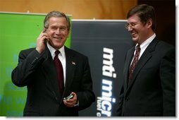 President George W. Bush tries out a cell phone powered by hydrogen fuel cell technology during a demonstration of energy technologies at The National Building Museum in Washington, D.C., Thursday, Feb. 6, 2003. Accompanied by EPA Administrator Christie Todd Whitman and Department of Energy Secretary Spencer Abraham, the President reviewed fuel cell technology in applications ranging from cars to laptop computers. White House photo by Paul Morse.