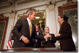 President Bush greets Nancy Coverdell after signing in honor of her husband, Paul Coverdell, a former director of the Peace Corps, Thursday, July 26, 2001. "Paul Coverdell was a man of unusual abilities and striking character. He spoke with candor when others might hide the unpleasant truth," said the President during his remarks. "He understood every parent's hopes for a quality education. So he pressed for tax-free savings accounts for education expenses. Today, his idea is law. And today, we rename those accounts for him: The Coverdell Education Savings Accounts.". White House photo by Eric Draper.