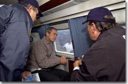 President George W. Bush tours the World Trade Center disaster site aboard Marine One with New York Mayor Rudolph Giuliani, left, and New York Governor George Pataki, Friday, Sept. 14, 2001. White House photo by Eric Draper.