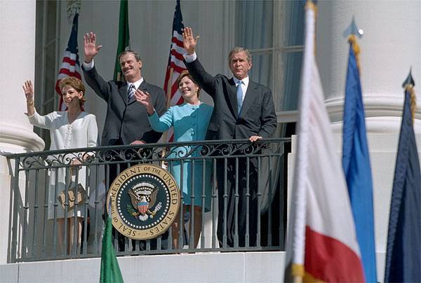 Waving from the White House balcony, President Bush welcomes Mexican President Vicente Fox during the President's First State Visit Sept. 6.
