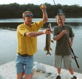 Photo of a father and son fishing.