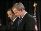President George W. Bush joins Marc Morial, President of the National Urban League, in prayer on stage before delivering remarks in Detroit, Mich., Friday, July 23, 2004. White House photo by Eric Draper.