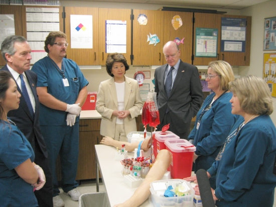 Commerce Secretary Don Evans (second from left), Labor Secretary Elaine L. Chao (center), and Treasury Secretary John W. Snow (third from right) visit the phlebotomy training lab during their tour of the Mayo Clinic in Rochester, Minn., on July 30. (DOL Photo/Sean Redmond)
