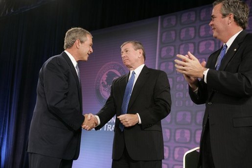 President George W. Bush is congratulated by Attorney General John Ashcroft and Florida Governor Jeb Bush after making remarks at the National Training Conference on Combating Human Trafficking in Tampa, Florida on Friday July 16, 2004. White House photo by Paul Morse.