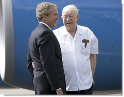 President George W. Bush chats with Freedom Corps greeter Scotty Maconochie after landing in Waterford, Michigan on Wednesday July 7, 2004. White House photo by Paul Morse.