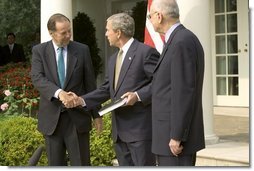 Accompanied by Chairman Thomas Kean, left, and Vice Chairman Lee Hamilton of the 911 Commission, President George W. Bush addresses the press during the presentation of the Commission's report in the Rose Garden Thursday, July 22, 2004. White House photo by Eric Draper.