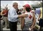 President George W. Bush talks to an American Red Cross worker while touring relief efforts in response to Hurricane Frances damage in Ft. Pierce, Fla., Wednesday, Sept. 8, 2004. White House photo by Eric Draper.
