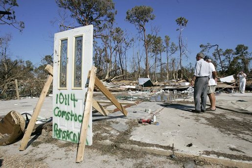 President George W. Bush stands with Al Boyd in the ruins of where Boyd's home used to be during a walking tour of neighborhoods damaged by Hurricane Ivan in Pensacola, Florida, Sunday, Sept. 19, 2004. White House photo by Eric Draper.