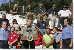 President George W. Bush discusses the recovery efforts at the Millvale, Pa. Fire Department in Western Pennsylvania during a visit to the area recently flooded by Tropical Depression Ivan in Allegheny County, Wednesday, Sept. 22, 2004. White House photo by Eric Draper.