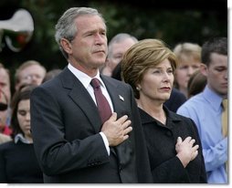 President George W. Bush and Mrs. Bush pause during the playing of Taps following the Moment of Silence on the South Lawn, Saturday, Sept. 11, 2004. White House photo by Eric Draper.
