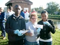 Henniger High School students (Nazir Ibriham, left, and Jimeisha McBride, right) and teacher (Suzanne DeTore, middle) montoring water quality in Onondaga Creek, Syracuse, NY.