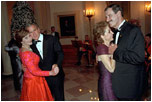 Leading their wives in the first dance of the evening, Presidents Bush and Mexican President Vicente Fox take to the floor during the state dinner held on September 5, 2001. 