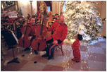 A member of the Marine Band greets a young fan in the Cross Hall during the 2001 holiday season at the White House.