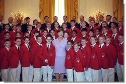 Laura Bush poses with the Philadelphia Boys Choir following their performance at the Senate Spouses Luncheon in the East Room June 4, 2001. White House photo by Susan Sterner.
